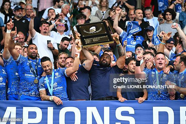 Vannes' players lift the shield after winning the French Pro D2 rugby union final match between RC Vannes and Provence Rugby at the Ernest Wallon...