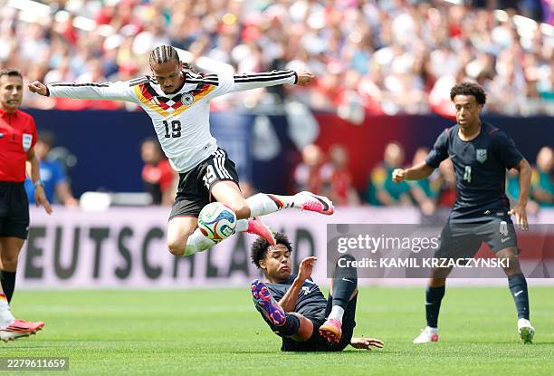 Germany's Leroy Sane jumps over Weston McKennie of the US during the international friendly football match between USA and Germany at Soldier Field...