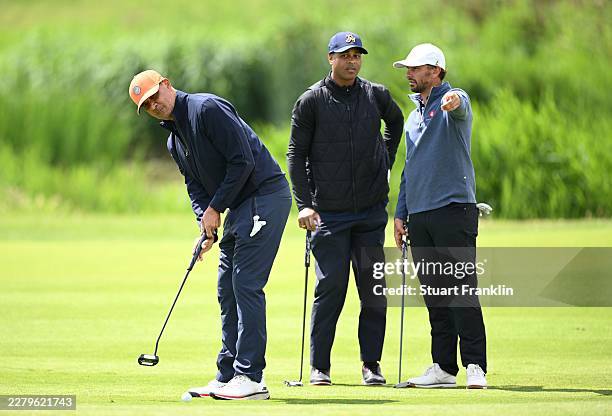 Former Dutch footballer Patrick Kluivert and Joost Luiten of The Netherlands, discuss a shot as Ruud Gullit, KLM tournament Director putts during the...