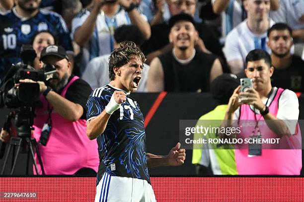Argentina's forward Giuliano Simeone celebrates after scoring his team's second goal during the international friendly football match between...