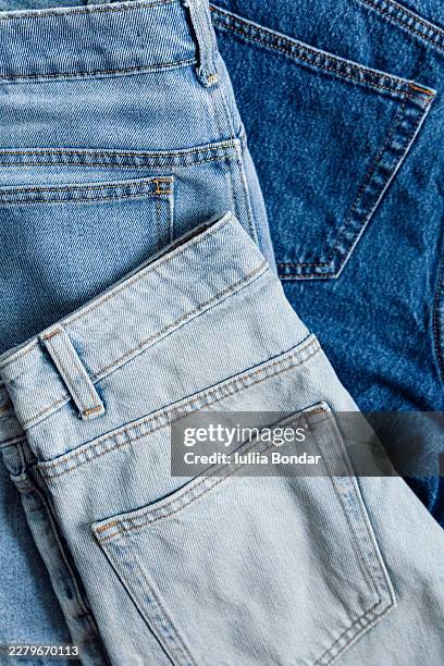 light and dark blue denim clothing layered together - denim stock pictures, royalty-free photos & images
