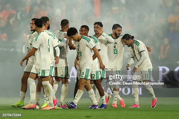 Anis Hadj Moussa of Algeria celebrates scoring his team's first goal with teammates during the international friendly match between Netherlands and...