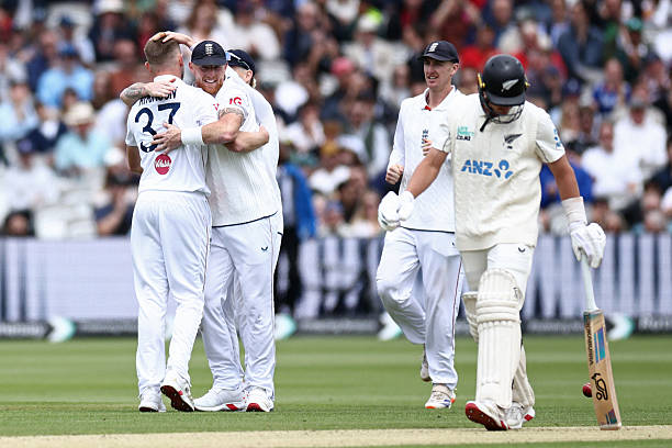 England's Gus Atkinson celebrates taking the wicket of New Zealand's Nathan Smith with England's captain Ben Stokes on the fourth day of the first...