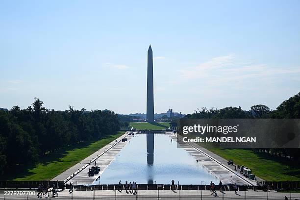Visitors walk past the partially filled Lincoln Memorial Reflecting Pool as renovation work continues on the National Mall in Washington, DC, on June...