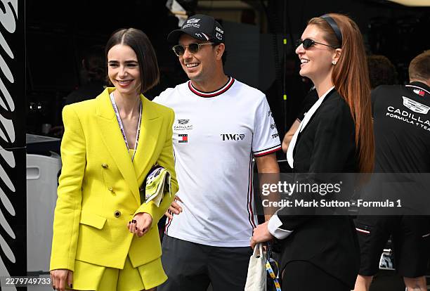 Sergio Perez of Mexico and Cadillac F1 Team poses for a photo with Lily Collins in the Paddock during previews ahead of the F1 Grand Prix of Monaco...