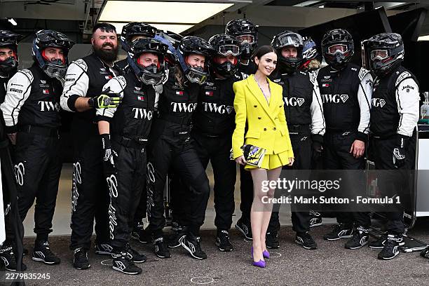 Lily Collins with the Cadillac F1 Team pit crew during previews ahead of the F1 Grand Prix of Monaco at Circuit de Monaco on June 04, 2026 in...