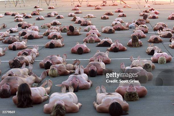 An estimated 100 people posed nude for controversial artist/photographer Spencer Tunick at Woodstock 99 in Rome, New York. The Woodstock 99 festival...