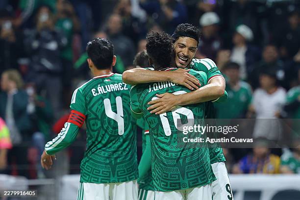 Raúl Jiménez of Mexico celebrates with teammate Julian Quiñones after scoring the team's third goal during the international friendly match between...