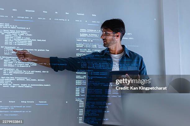 male programmer discussing ai coding strategy during team collaboration in office. - software programmer stock pictures, royalty-free photos & images