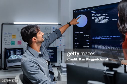 Programmers Reviewing Machine Learning Results and Coding Tasks During Team Session. Programmers Reviewing Machine Learning Results and Coding Tasks During Team Session.