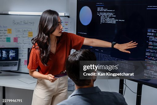 Programmer and Software Engineer Discussing Technical Planning and Data Analysis in Modern Office. Programmer and Software Engineer Discussing Technical Planning and Data Analysis in Modern Office.