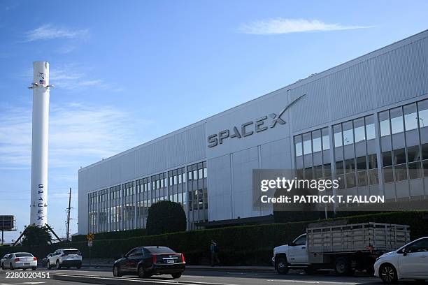 Vehicles drive past a SpaceX Falcon 9 rocket displayed outside a Space Exploration Technologies Corp. Facility in Hawthorne, California, on June 8,...
