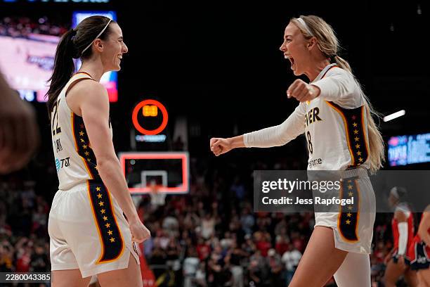 Caitlin Clark of the Indiana Fever celebrates with Sophie Cunningham after scoring the game-winning three pointer during the second half against the...