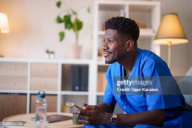 healthcare worker using smartphone after work - internship program stock pictures, royalty-free photos & images