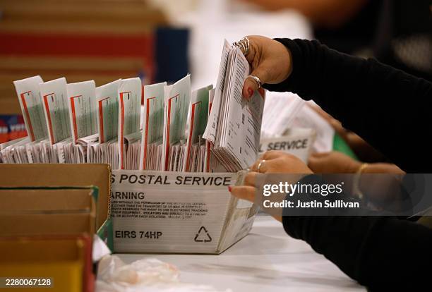 An election worker processes mail-in ballots for the California state primary election at the Los Angeles County Ballot Processing Center on June 05,...
