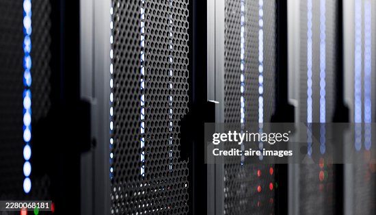 Server racks with blinking blue lights showing cloud computing infrastructure Server racks with blinking blue lights showing cloud computing infrastructure