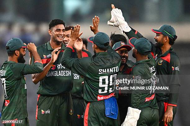 Bangladesh's Nahid Rana celebrates with teammates after taking the wicket of Australia's Liam Scott during the first one-day international cricket...