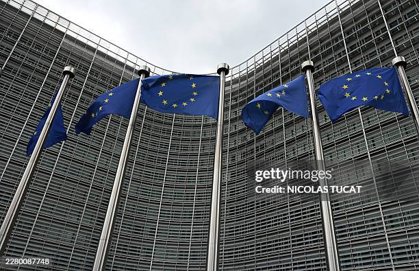 This photograph shows European Union flags in front of the Berlaymont building, the EU Commission headquarters, in Brussels on June 9, 2026.