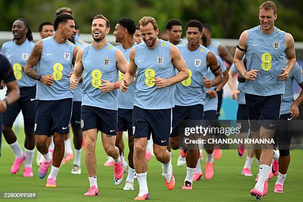 England's midfielder Morgan Rogers, England's midfielder Jordan Henderson, England's forward Harry Kane, England's midfielder Jude Bellingham and...