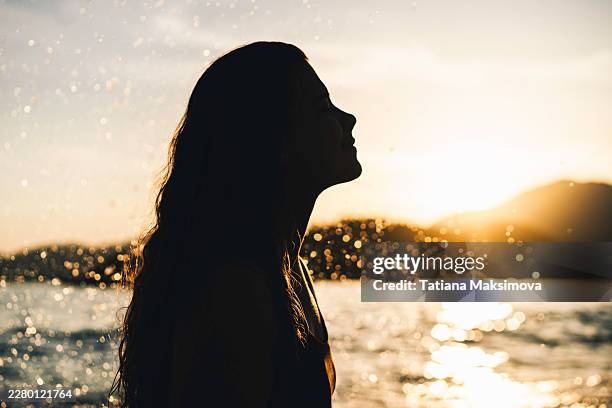beautiful woman portrait in sunset light. black silhouette, profile view. - astrologie stockfoto's en -beelden