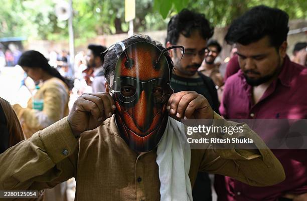 Supporter of CJP wears a cockroach mask during a protest demanding the resignation of the Education Minister over alleged examination paper leaks, on...