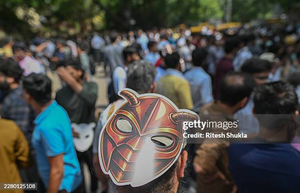 Supporter of CJP wears a cockroach mask during a protest demanding the resignation of the Education Minister over alleged examination paper leaks on...