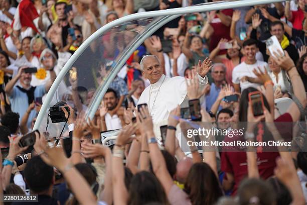 Pope Leo XIV waves to the faithful as he arrives to lead a prayer vigil at the Lluís Companys Olympic Stadium on June 9, 2026 in Barcelona, Spain....