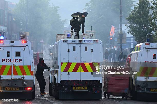 Protestors attack a Police vehicle on Sandy Row on June 9, 2026 in Belfast, Northern Ireland. Demonstrations have been called in reaction to what...