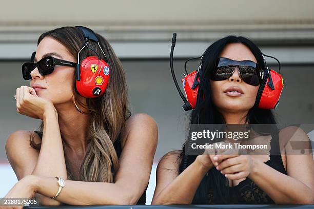Khloe Kardashian and Kim Kardashian look on above the Scuderia Ferrari garage in the Pitlane during qualifying ahead of the F1 Grand Prix of Monaco...