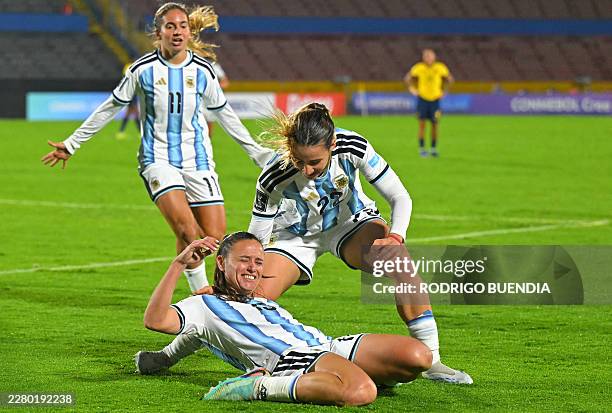 Argentina's defender Maria Bonsegundo celebrates with her teammates Argentina's forward Mercedez Diz and Argentina's forward Francisca Altgelt after...