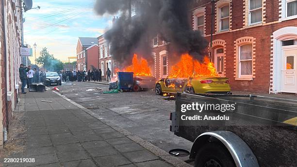 Flames and thick black smoke rise from a vehicle during unrest on Sandy Row in Belfast, Northern Ireland, on June 9, 2026. Demonstrations followed a...