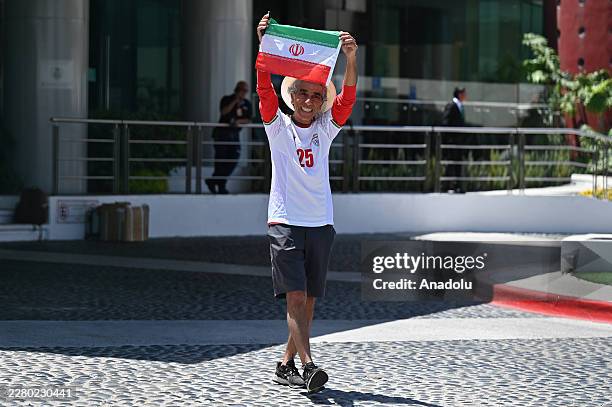 Mostafa Pourmanda, an Iranian supporter living in San Diego, California and staying at the same hotel as Iran's national football team, shows a flag...