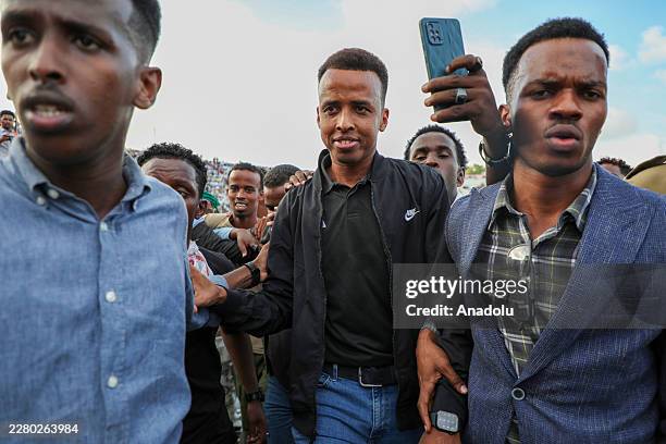 Somali referee Omar Abdulkadir Artan greets fans who show support for him, after he was denied entry into the United States where he had traveled to...