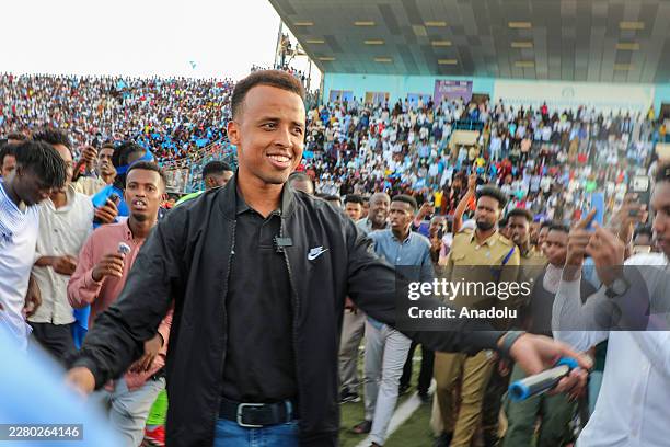 Somali referee Omar Abdulkadir Artan greets fans who show support for him, after he was denied entry into the United States where he had traveled to...