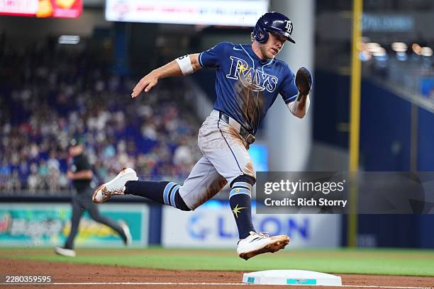 Taylor Walls of the Tampa Bay Rays rounds third base on his way home to score against the Miami Marlins during the third inning at loanDepot park on...