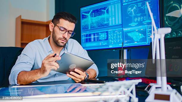 modern engineer designing wind turbine for sustainable energy solutions. - mathematical function stock pictures, royalty-free photos & images