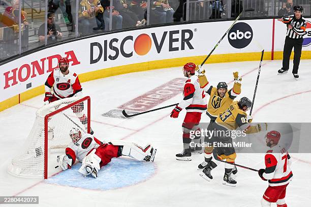 William Karlsson and Mitch Marner of the Vegas Golden Knights celebrate after a slap shot by Shea Theodore bounced off the end boards and then off of...