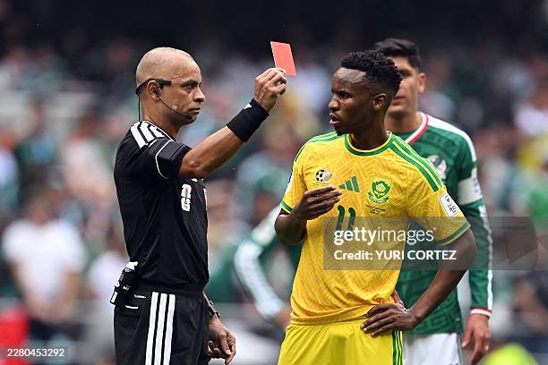 Brazilian referee Wilton Sampaio shows a red card to South Africa's midfielder Themba Zwane during the 2026 World Cup Group A football match between...