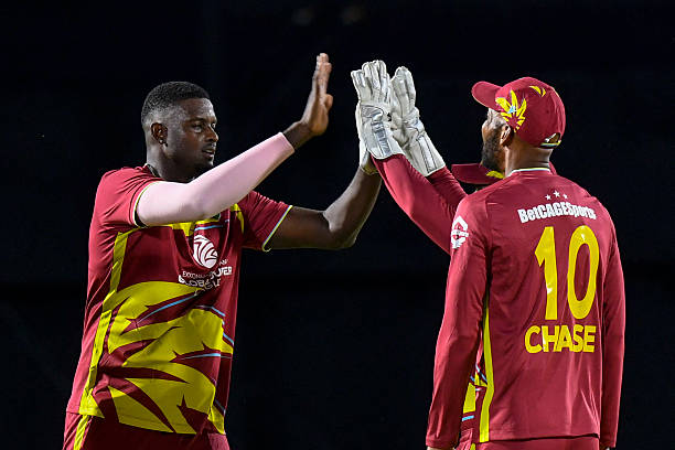Jason Holder of West Indies celebrates the dismissal of unseen Pathum Nissanka of Sri Lanka with teammates during the first Twenty20 international...