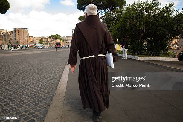 franciscan friar walking near the roman forum in rome - friar stock pictures, royalty-free photos & images