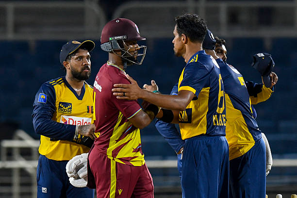 Maheesh Theekshana and Kusal Mendis of Sri Lanka congratulate Shai Hope of West Indies after West Indies' victory in the first Twenty20 international...