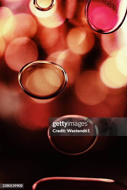 abstract bubbles in colorful liquid with glowing bokeh background - volatility abstract stock illustrations