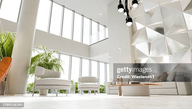modern minimalistic hotel reception lounge with geometric wall and copy space - empty coffee table stock illustrations