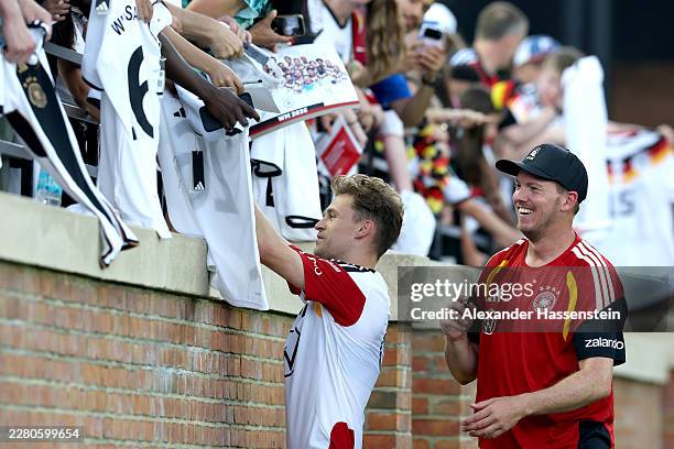 Julian Nagelsmann, Head Coach of Team Germany signs autographs with his player Joshua Kimmich after a Team Germany training session at W. Dennie Spry...