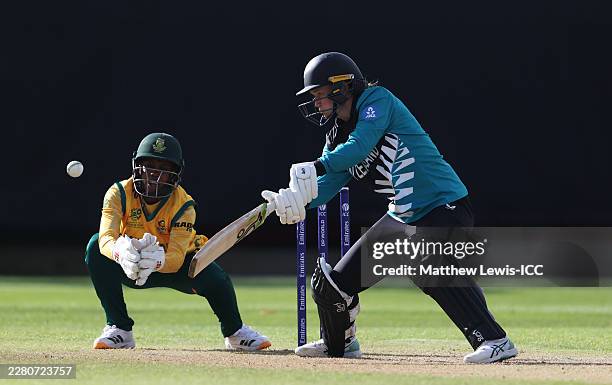 Maddy Green of New Zealand hits the ball towards the boundary, as Karabo Meso of South Africa watches on during the ICC Women's T20 World Cup England...