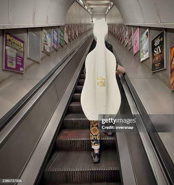 london escalator and cello case - cello case stock pictures, royalty-free photos & images