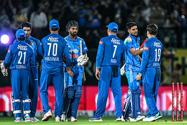 India's captain Shubman Gill and his teammate KL Rahul shake hands with Afghanistan's players at the end of the first one-day international cricket...