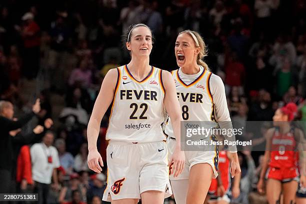 Caitlin Clark of the Indiana Fever celebrates with Sophie Cunningham after scoring the game-winning three pointer during the second half against the...