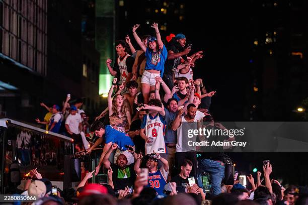 New York Knicks fans climb on buses as they celebrate after they win the NBA Finals in Times Square on June 14, 2026 in New York City. The New York...