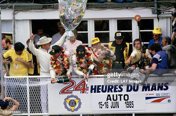 Drivers John Winter, Paolo Barilla and Klaus Ludwig, and Team Manager Reinhold Joest celebrate victory with champagne on the podium during the 24...